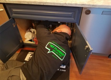 Plumber in Vancouver, WA fixing a faucet pipe